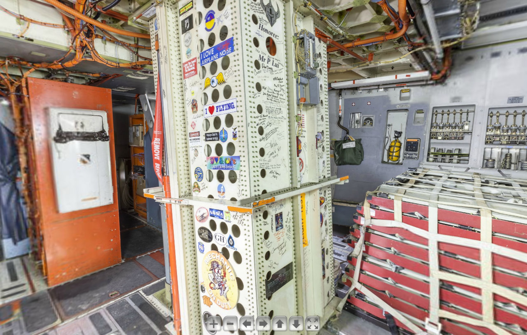 This screenshot shows the forward cargo area inside the Boeing C-17 Globemaster III on the National Museum of the U.S. Air Force's Virtual Tour website. In the bottom center of the photo, you can see stickers from the “Transformers” and “Iron Man” movies, along with autographs from “Iron Man” stars Robert Downey Jr. and Gwyneth Paltrow and director Jon Favreau. (U.S. Air Force image)