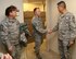 Chief Master Sergeant Brian Wong, Command Chief Master Sergeant, Fourth Air Force, talks about training on the flight line while shaking hands with Master Sgt. Darren Wiseman, during a visit to the 932nd Airlift Wing. This was Chief Wong's first visit to Scott Air Force Base. Fourth Air Force has command supervision of the Air Force Reserve's long-range airlift and air-refueling units located throughout the continental United States, Hawaii and Guam.  Listening in is Senior Master Sgt. Shana Cullum, First Sergeant.  (U.S. Air Force Photo/ Staff Sgt. Amber Hodges) 