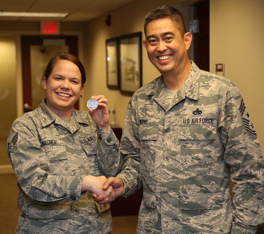 Senior Airman Deanne Wagner receives a special recognition coin from Chief Master Sergeant Brian Wong, Command Chief Master Sergeant, Fourth Air Force.   She was recognized for her work in the 932nd Aeromedical Evacuation Squadron.  This was Chief Wong's first visit to Scott Air Force Base. He was able to make visits throughout the 932nd Airlift Wing.  (U.S. Air Force photo/Tech Sgt. Christopher Parr)