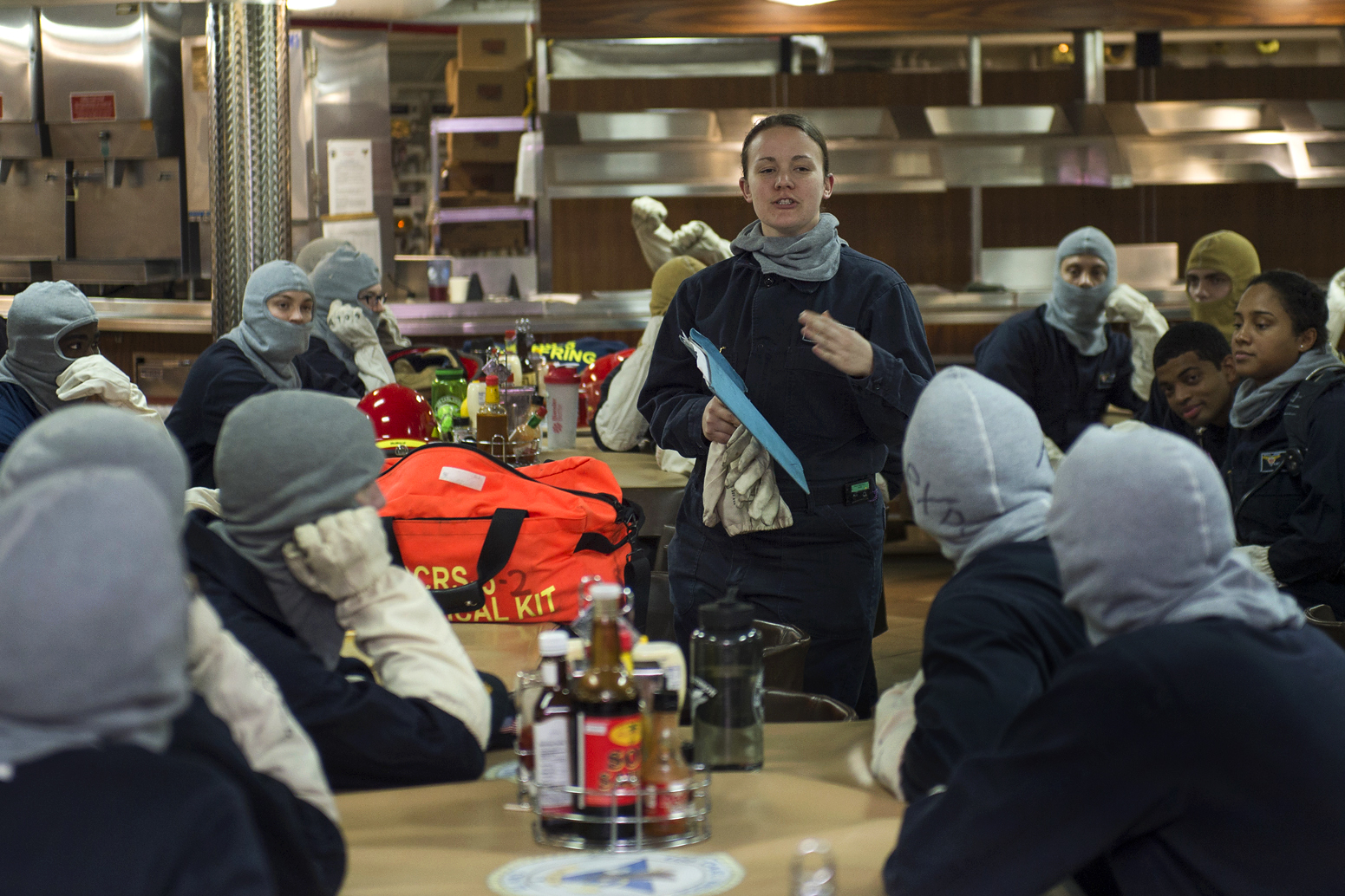 U.S. Navy Petty Officer 2nd Class Stephanie Dewitt, center, conducts