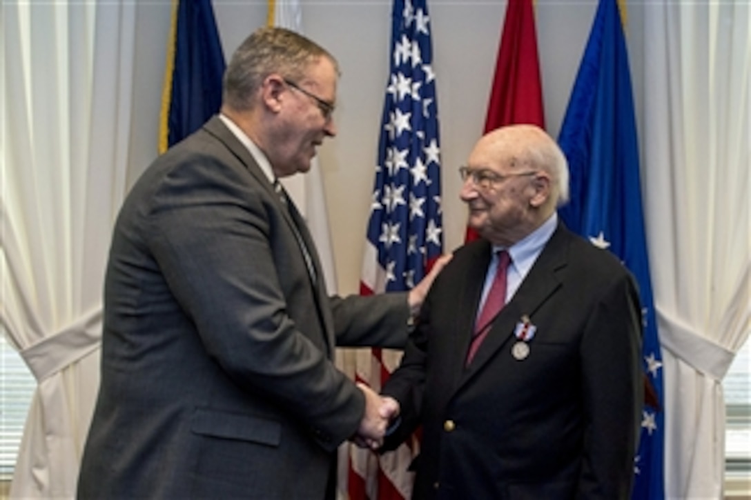 Deputy Defense Secretary Bob Work hosts a farewell ceremony for Andrew M. Marshall at the Pentagon, Jan. 5, 2015. Marshall, 93, worked his last day as director of the Defense Department's Office of Net Assessment, retiring after 42 years.