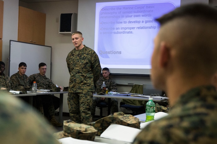 Sgt. Brandon Webster, an instructor with Headquarters and Headquarters Squadron's Lance Corporal Leadership and Ethics Seminar, speaks to the class inside Building One aboard Marine Corps Air Station Iwakuni, Japan. Starting Oct. 1, 2015, lance corporals will be required to complete a command-sponsored seminar in or to pick up the next rank.