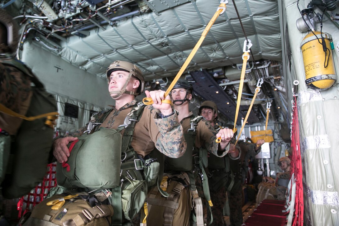 Marines prepare to jump from a KC-130J Super Hercules aircraft Nov. 20, 2014 over Ie Shima Training Facility, off the northwest coast of Okinawa, Japan. The training gave the Marines added experience with air drop operations while also maintaining their jump proficiency. The Marines are with 3rd Reconnaissance Battalion, 3rd Marine 
