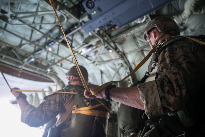 Marines prepare to jump from a KC-130J Super Hercules aircraft Nov. 20, 2014 over Ie Shima Training Facility, off the northwest coast of Okinawa, Japan. The low level static line jumps were performed at an altitude of 1,500 feet for the training. The Marines are with 3rd Reconnaissance Battalion, 3rd Marine Division, III Marine Expeditionary Force. 