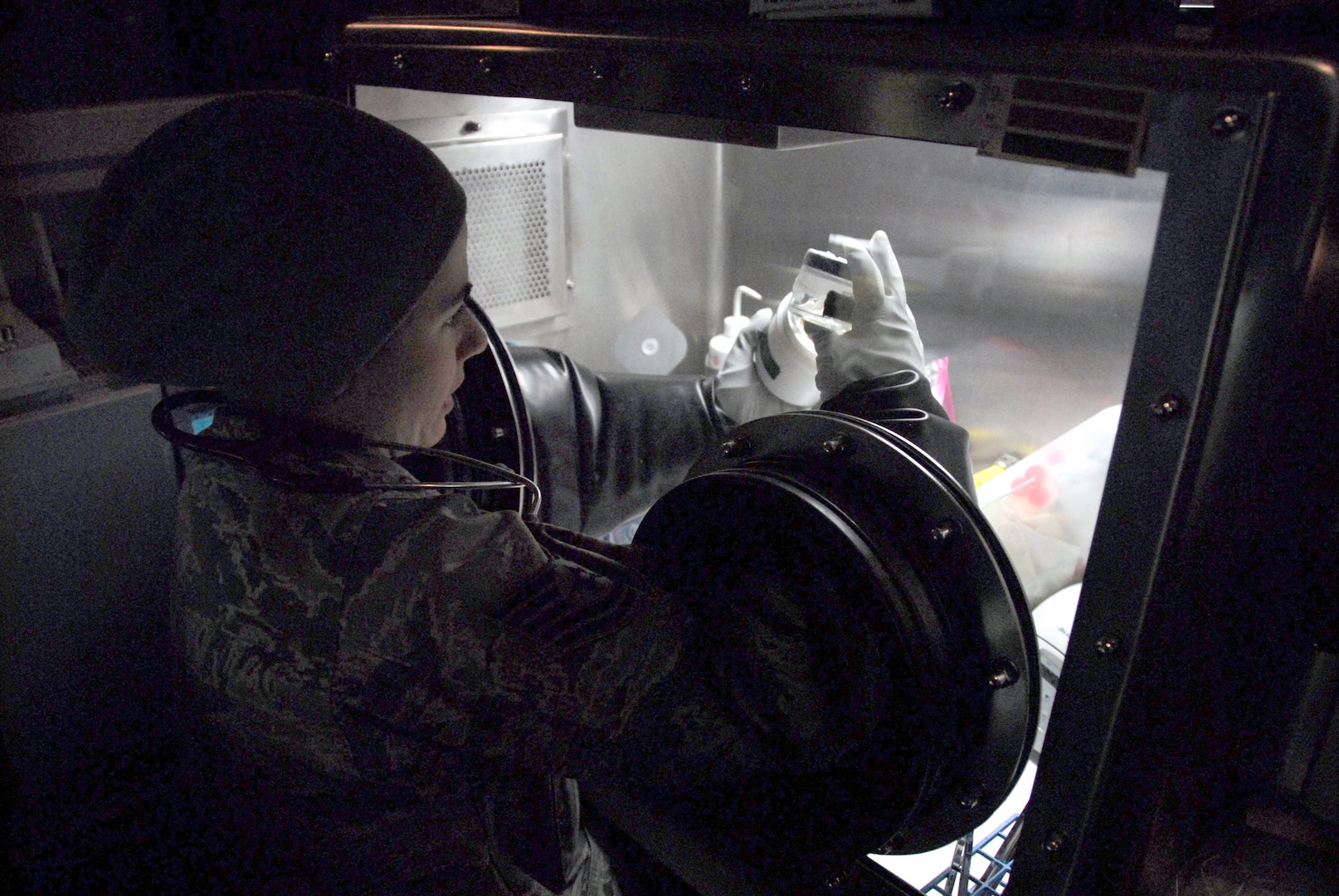 Tech. Sgt. Charlotte Koshek analyzes a sample drawn from a "contaminated" room in the VIP Lodge at Alpine Valley Music Theatre during an Army North external evaluation of the Wisconsin National Guard's 54th Civil Support Team on March 25, 2010. The evaluation is required every 18 months for unit certification. In the exercise scenario, a winter concert by rock groups promoting animal cruelty was sabotaged with chemical, biological and radiological materials by an animal rights group.