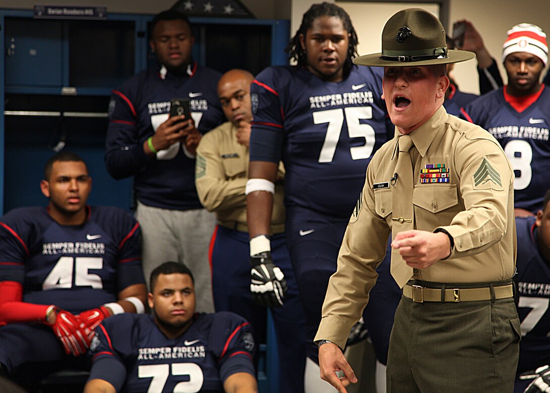 CARSON, Calif., - Sergeant Ivan Colina, a drill instructor from Marine Corps Recruit Depot Parris Island, S.C., speaks with the players of Team East before the Semper Fidelis All-American Bowl Jan. 4, 2015, at The StubHub Center. Colina spent a week with the Team East helping preparing, motivating and teaching Marine Corps values to the players. (U.S. Marine Corps photo by Sgt. Erik S. Brooks Jr.)