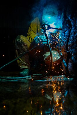 Senior Airman John Lee welds material for use in constructing an ice bridge Dec. 2, 2014, at Eielson Air Force Base, Alaska. The bridge must be constructed every other year to provide access to the $20 million range complex used to train pilots from around the world during Red Flag-Alaska exercises. Lee is a range maintenance structures journeyman assigned to the 354th Civil Engineer Squadron on Eielson Air Force Base, Alaska. (U.S. Air Force photo/Tech. Sgt. Joseph Swafford)