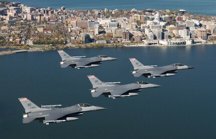 Four F-16 Fighting Falcons from the 115th Fighter Wing fly in formation over Lake Monona, Wisconsin.  Some Airmen and jets will be deploying to Japan this month.