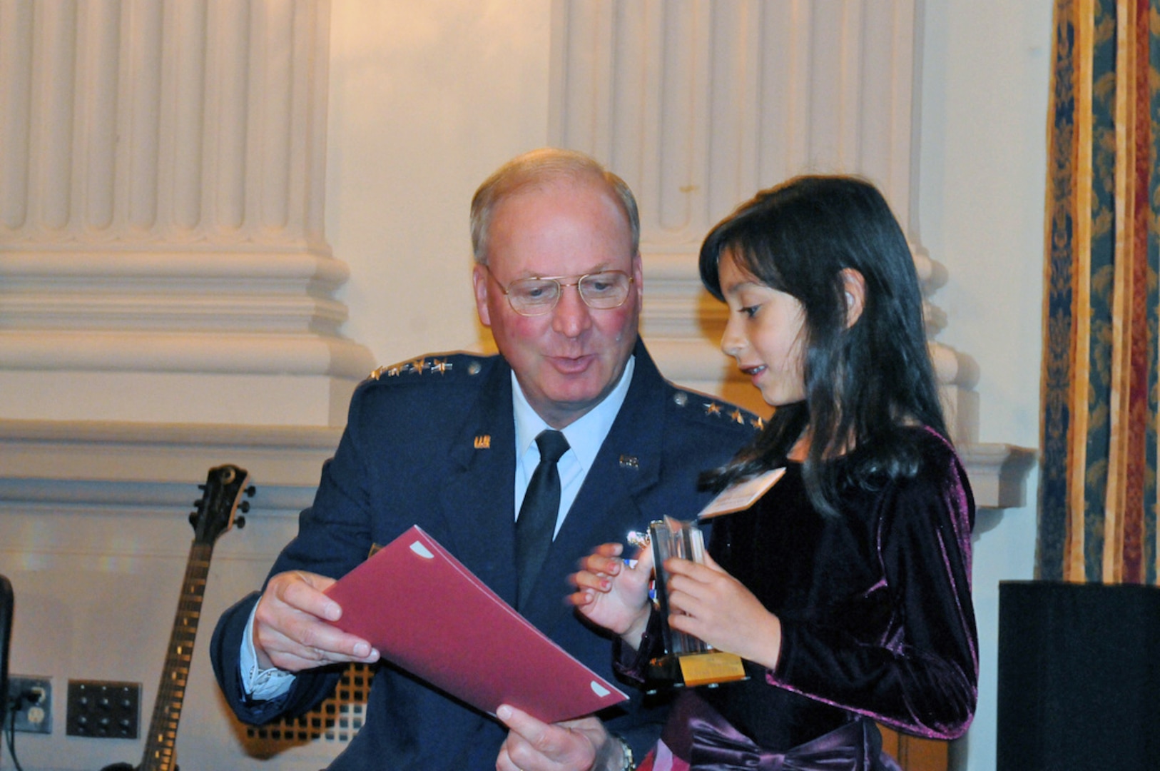 Air Force Gen. Craig McKinley, the chief of the National Guard Bureau, recognizes Valerie Gonzalez as a 2010 Our Military Kid of the Year at a ceremony at the Cannon House Office Building in Washington, D.C., on April 13, 2010. The daughter or a deployed servicemember, Valerie received a grant from Our Military Kids that paid for extracurricular activities while her father was overseas and she created an "Adopt a Soldier" program at her school that collected boxes of items to be sent to troops serving abroad. Our Military Kids has helped more than 17,000 children of National Guard and Reserve servicemembers with grants for enrichment activities and tutoring that nurture and sustain the children during the time a parent is away in service to our country.