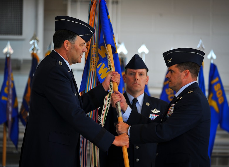 Lt. Gen. Bradley Heithold, Air Force Special Operations Command commander, passes the 1st Special Operations Wing guidon to Col. Sean Farrell, 1st SOW commander, during a change of command ceremony at the Freedom Hangar on Hurlburt Field, Fla., Jan. 6, 2015. Farrell assumed command of the 1st Special Operations Wing. (U.S. Air Force photo/Senior Airman Christopher Callaway) 