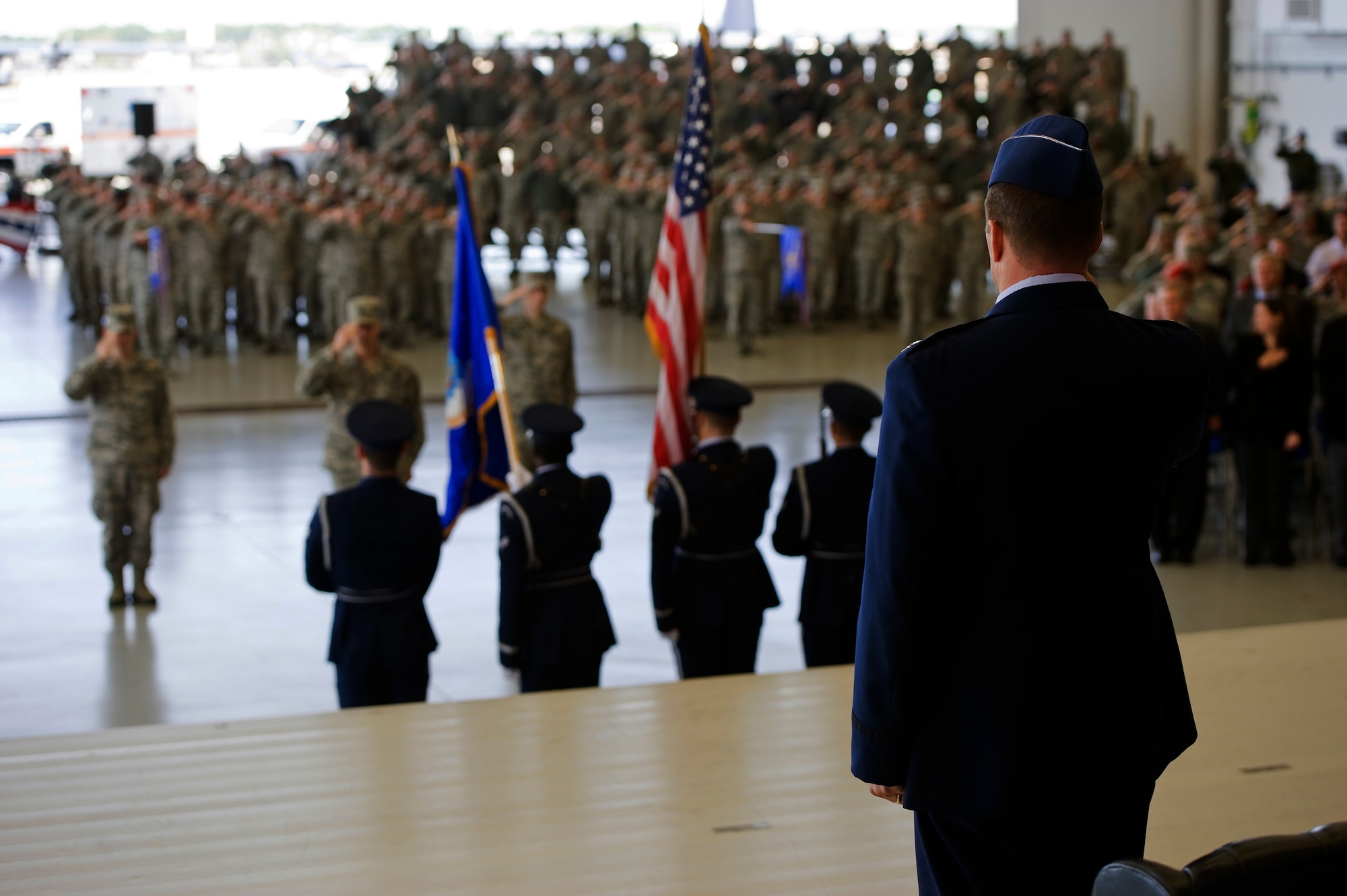 Air Commandos salute during the singing of the national anthem at the 1st Special Operations Wing change of command ceremony here, Jan. 6, 2015 Col. Sean Farrell assumed command of the 1st SOW from Col. Bill West during the ceremony.  (U.S. Air Force photo/Staff Sgt. Kentavist P. Brackin)