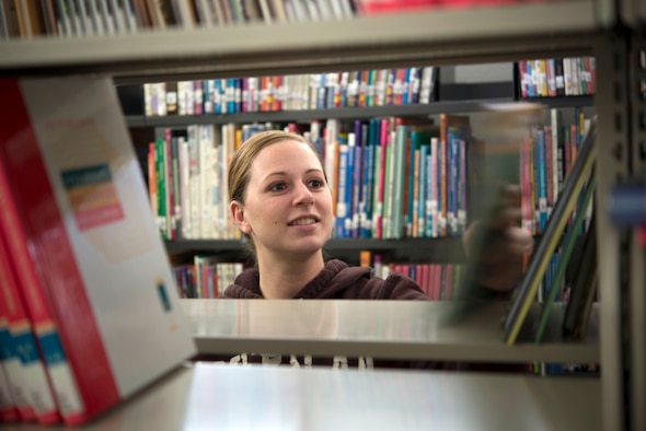 Tech. Sgt. Michelle Murphy, 19th Air Force non-commissioned officer in charge, moves books during the relocation of the Universal City Public Library outside of Joint Base San Antonio-Randolph. With the help of volunteers from the JBSA-Randolph Rising 5/6 organization, Murphy spearheaded the relocation of roughly 27,000 items, to include books, movies, audiobooks, supplies and some furniture. (U.S. Air Force photo by Tech. Sgt. Beth Anschutz)