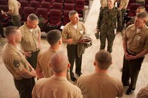 Chief Warrant Officer 4 Roderick W. Palmer, center, from Tallahassee, Florida, congratulates his rifle team Dec. 19 at Camp Hansen for their participation in the Far East Division Matches. The team won the Lloyd Trophy for receiving the highest score of the 19 rifle teams that competed in the matches. The trophy is named in honor of Maj. Calvin A. Lloyd, who won this trophy in the 1912 Pan-American Matches in Buenos Aires, Argentina. Palmer is a communications maintenance officer with Combat Logistics Regiment 35, 3rd Marine Logistics Group, III Marine Expeditionary Force.  (U.S. Marine Corps Photo by Lance Cpl. Mandaline Hatch/Released)
