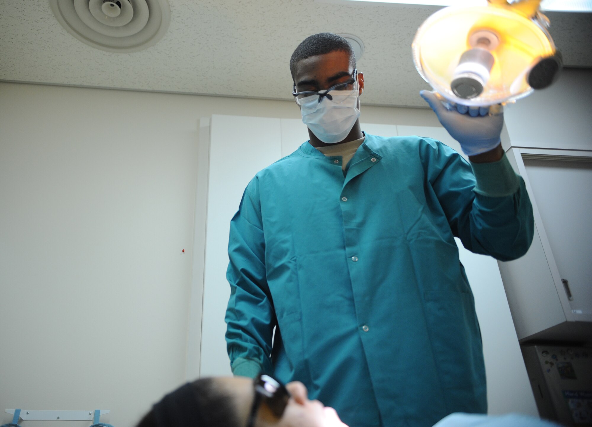 U.S. Air Force Airman 1st Class Christopher Walker, 35th Dental Squadron dental assistant, prepares and adjusts equipment for a dental procedure at Misawa Air Base, Japan, Dec. 2, 2014. Walker assists dentists to ensure military members receive the treatment needed to be ready to deploy at a moment’s notice. (U.S. Air Force photo by Airman 1st Class Jordyn Rucker/Released)