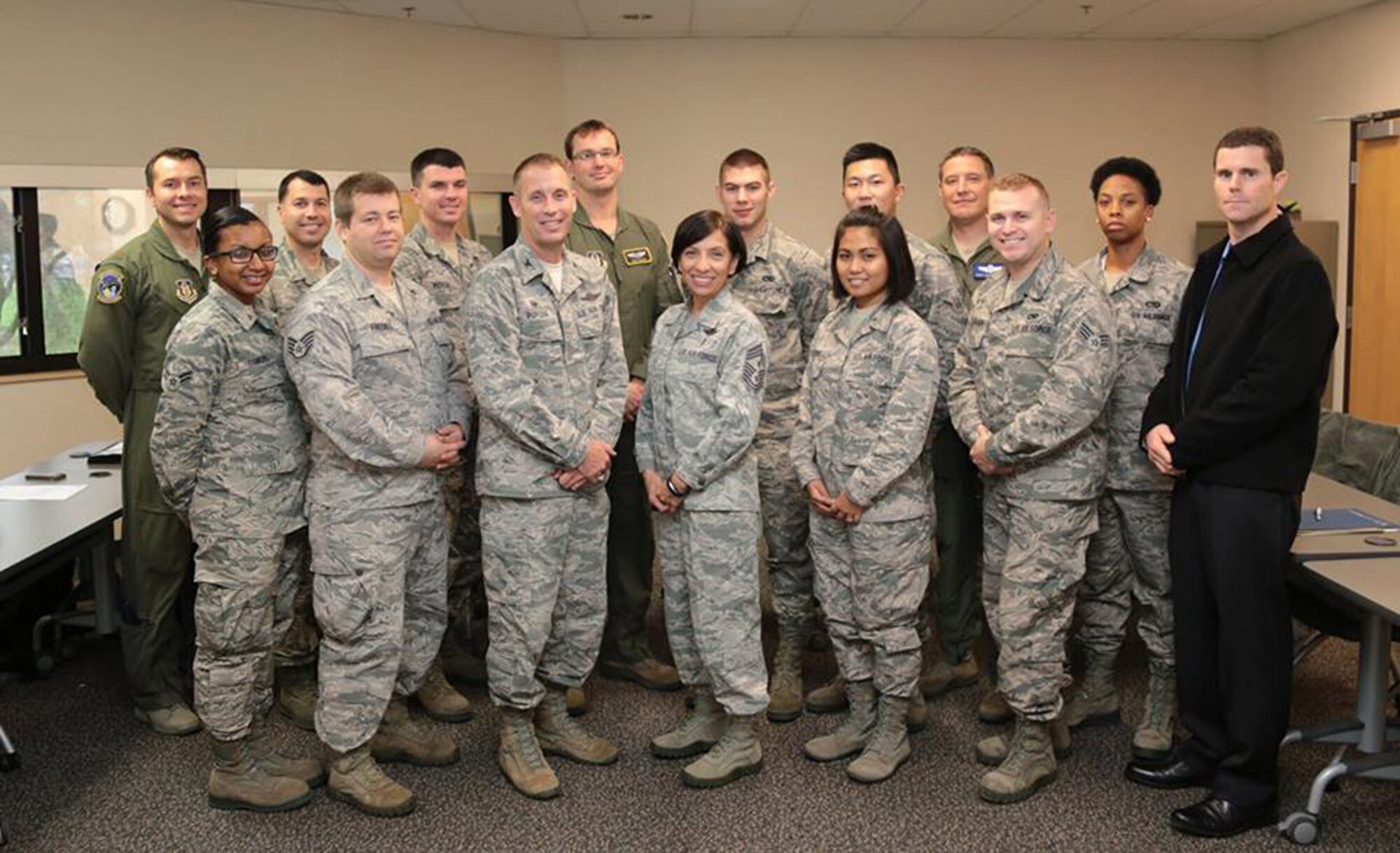 TRAVIS AIR FORCE BASE, Calif. -- Col. Matthew J. Burger, 349th Air Mobility Wing commander (center left) and Chief Master Sgt. Ericka E. Kelly, 349th Air Mobility Wing command chief master sergeant (center left), pose for a picture with the 12 newest members of the wing during newcomers orientation Dec. 20, 2014 at Travis Air Force Base, Calif. (U.S. Air Force photo/Lt. Col. Robert Couse-Baker)