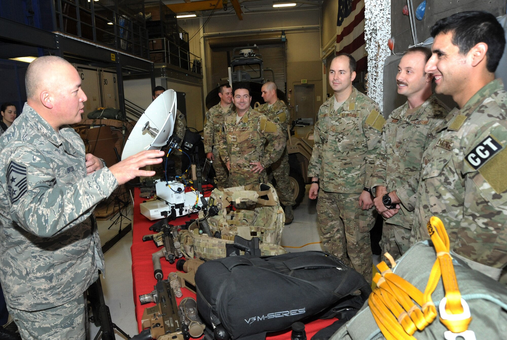 Chief Master Sgt. Mitchell O. Brush, Senior Enlisted Advisor for the National Guard Bureau, left, meets members of the 125th Special Tactics Squadron during his tour of the Portland Air National Guard Base, Ore., Jan. 5, 2015. Chief Brush received a briefing about the 125th mission and some of the unique equipment used by Airmen in the unit. (U.S. Air National Guard photo by Tech. Sgt. John Hughel, 142nd Fighter Wing Public Affairs/Released)