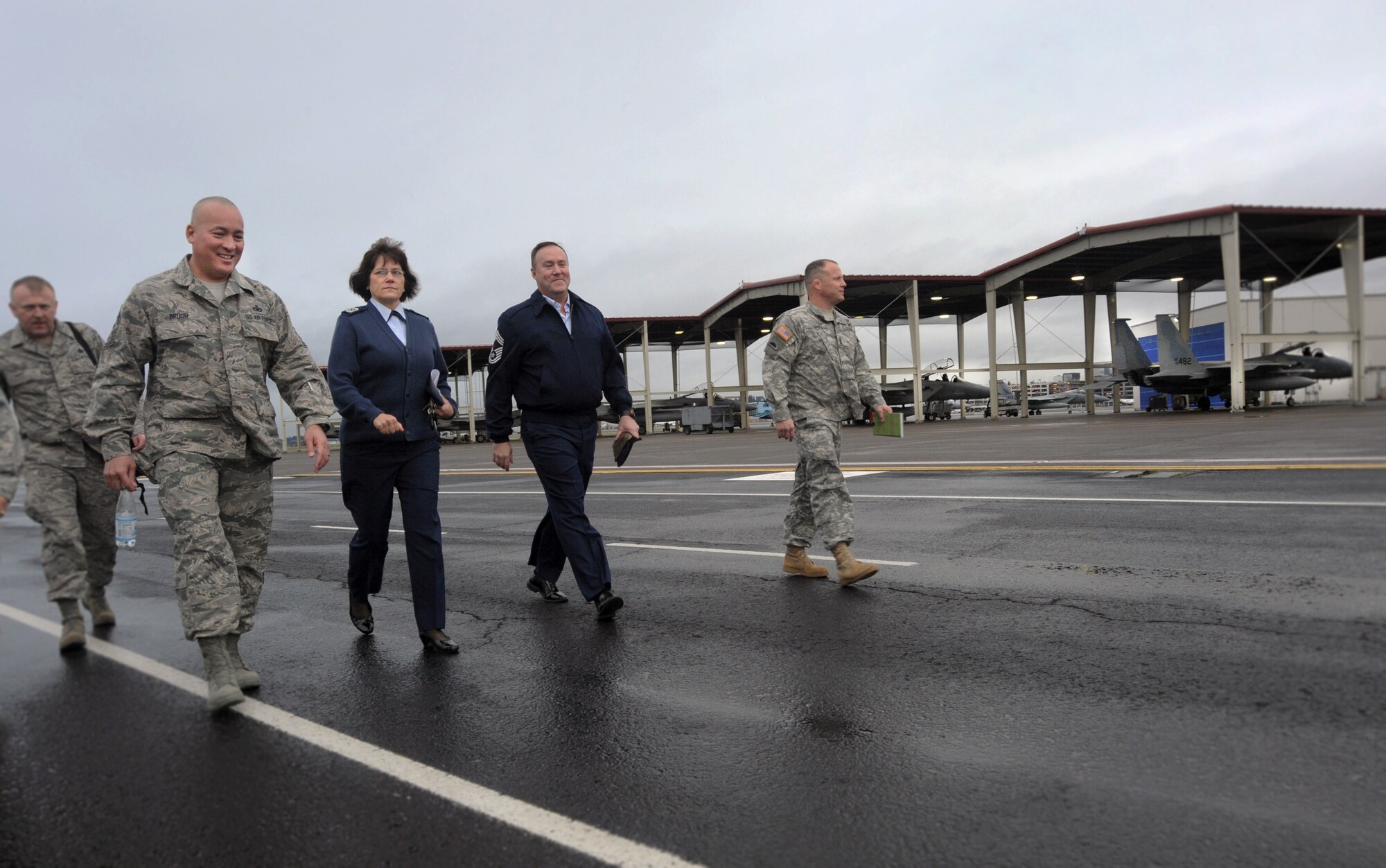 Chief Master Sgt. Mitchell O. Brush, Senior Enlisted Advisor for the National Guard Bureau, left, walks with Chief Master Sgt. Julie Eddings, center left, Chief Master Sgt. Christopher Roper, center right, and SGM Shane Lake, far right, along the flight line at the Portland Air National Guard Base, Ore., Jan. 5, 2015. Chief Brush toured the air base and led a town hall event to highlight the changes and challenges that Soldiers and Airmen of the National Guard face going into the New Year. (U.S. Air National Guard photo by Tech. Sgt. John Hughel, 142nd Fighter Wing Public Affairs/Released)