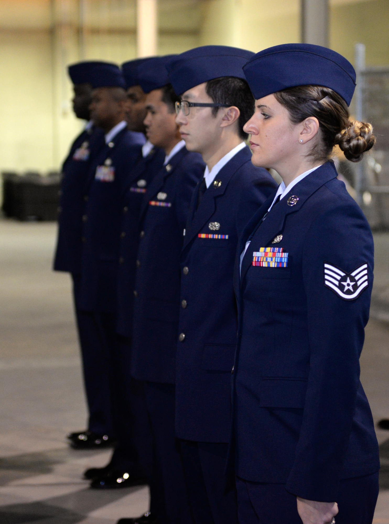 Airmen from the 2nd Logistics Readiness Squadron materiel management flight stand at attention during an open ranks inspection on Barksdale Air Force Base, La., Jan. 6, 2015. Open ranks is a part of drill which Airmen learn for the first time in basic military training and is used throughout an Airman's career. (U.S. Air Force photo/Airman 1st Class Curt Beach)