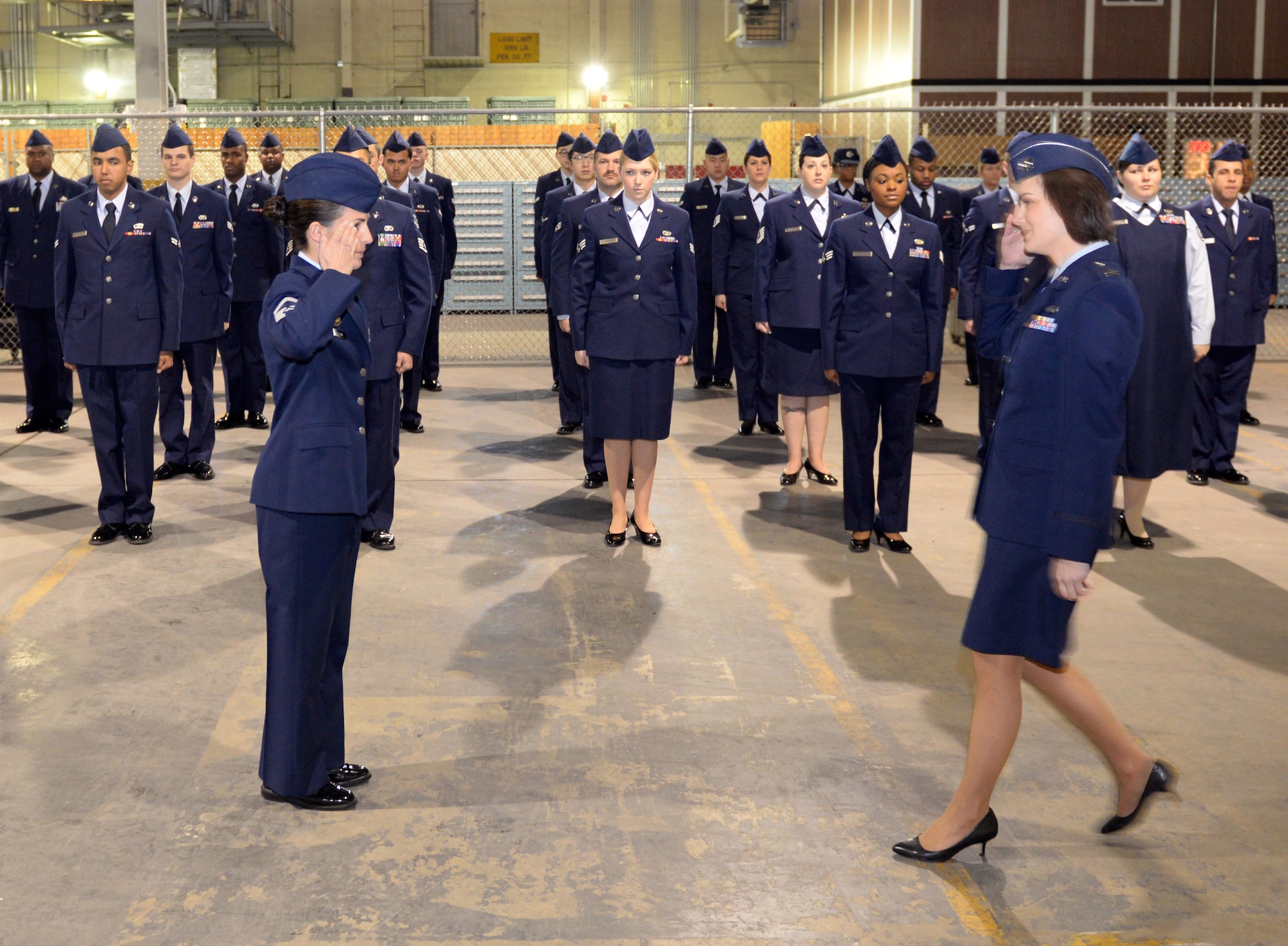 Senior Master Sgt. Elizabeth Olson, 2nd Logistics Readiness Squadron asset management superintendent, salutes Capt. Amanda Elliott, materiel management flight commander, as her flight is prepared for inspection on Barksdale Air Force Base, La., Jan. 6, 2015. Open ranks inspections are an important part of military tradition dating back more than 235 years, which was instilled by General Baron von Steuben, Revolutionary War veteran. (U.S. Air Force photo/Airman 1st Class Curt Beach)