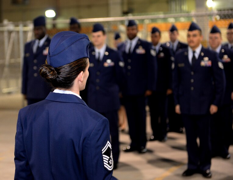 Senior Master Sgt. Elizabeth Olson, 2nd Logistics Readiness Squadron asset management superintendent, sizes up materiel management flight Airmen for inspection on Barksdale Air Force Base, La., Jan. 6, 2015. The Airmen of 2nd LRS take part in open ranks quarterly to ensure their service dress and appearance conform to Air Force standards. (U.S. Air Force photo/Airman 1st Class Curt Beach)