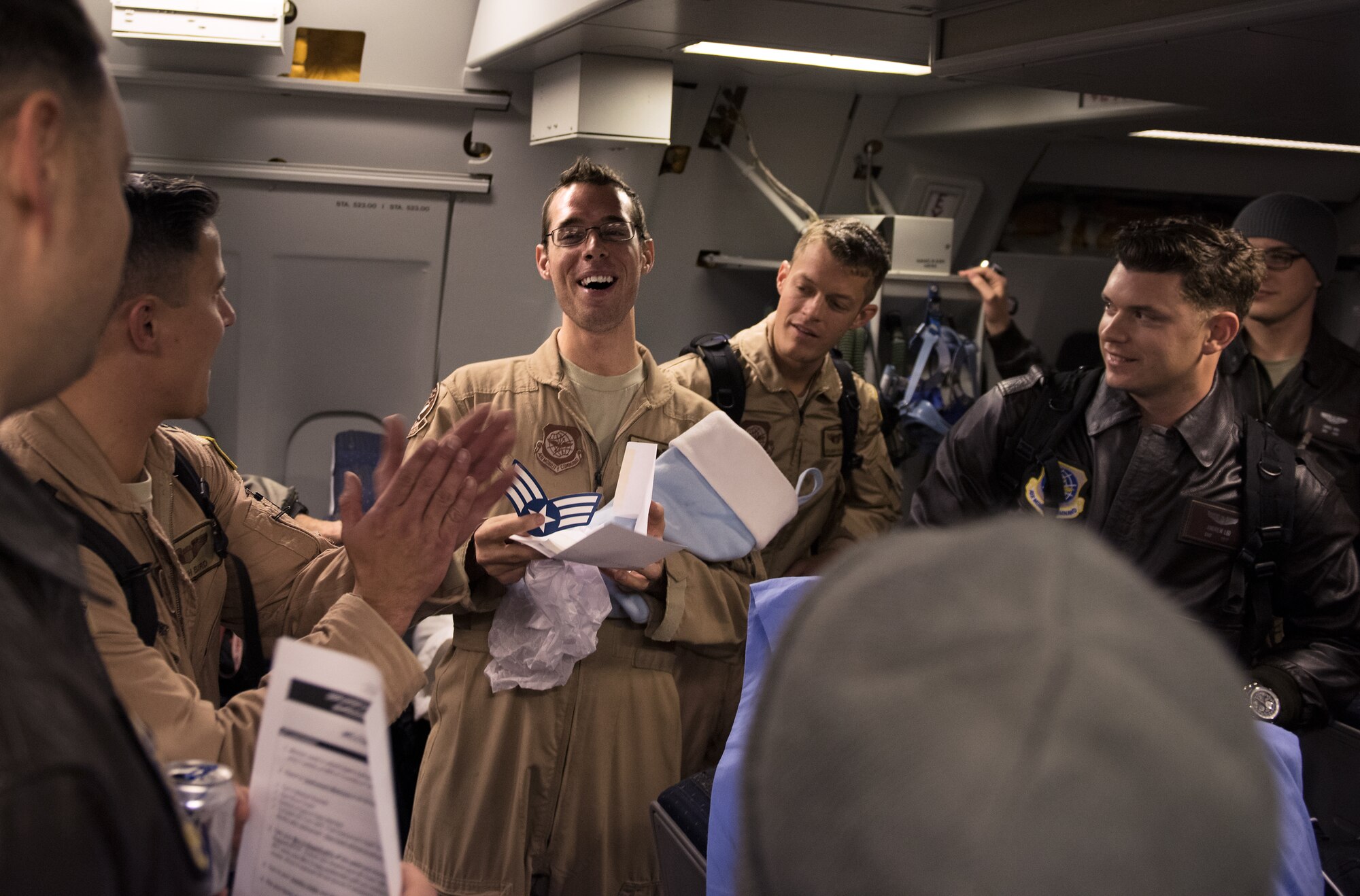 Airman 1st Class Kristoffer Pearson, 2nd Aerial Refueling Squadron boom operator, shows off his new senior airman stripes New Year's Eve at Joint Base McGuire-Dix-Lakehurst. Wing leaders presented Airman Pearson with the stripes upon his return from deployment. He was the sole member of the 305th AMW selected for a below-the-zone promotion. (U.S. Air Force photo/Staff Sgt. Katherine Tereyama/Released)