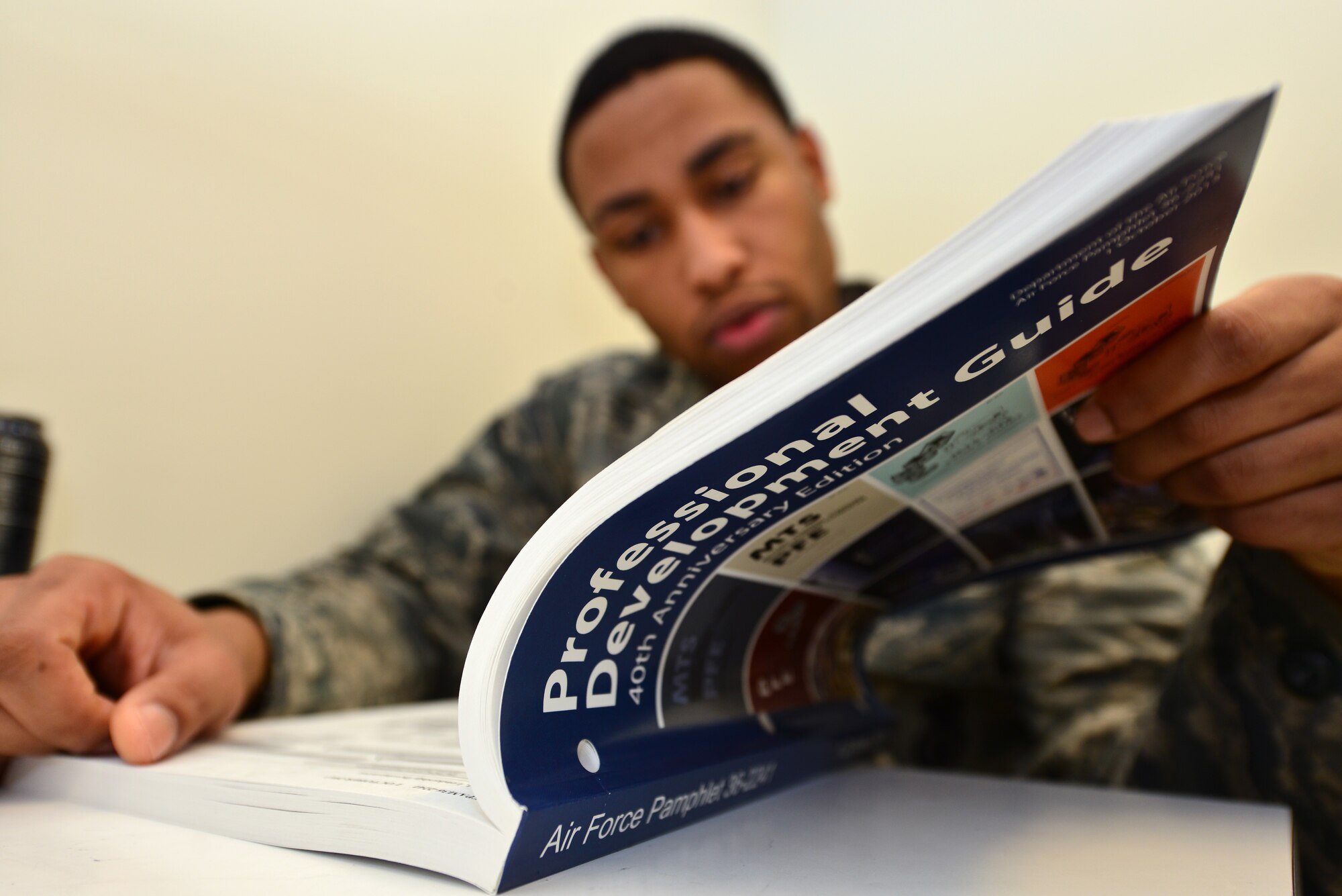U.S. Air Force Senior Airman Anthony Smith, III, 633rd Security Forces Squadron Virginia Criminal Information Network operator, studies Air Force Pamphlet 36-2241, Professional Development Guide, at Langley Air Force Base, Va., Jan. 6, 2015. One of Smith’s New Year’s resolutions is to promote to the rank of staff sergeant his first time testing. With promotion comes more responsibility, and according to Smith, he’s ready to take on that challenge. (U.S. Air Force photo by Senior Airman Aubrey White/Released)
