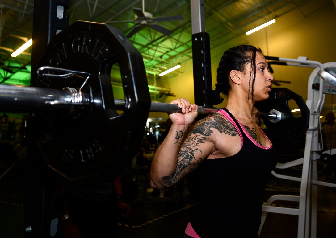 U.S. Air Force Senior Airman Kristin Delgado, 633rd Security Forces Squadron unit scheduling manager, performs squats at the Shellbank Fitness Center at Langley Air Force Base, Va., Jan. 6, 2015. Delgado aspires to compete in a female bodybuilding competition as her New Year’s resolution. Due to her schedule, she goes to the gym at 6 a.m., three times a week to reach her goals. (U.S. Air Force photo by Senior Airman Kayla Newman/Released