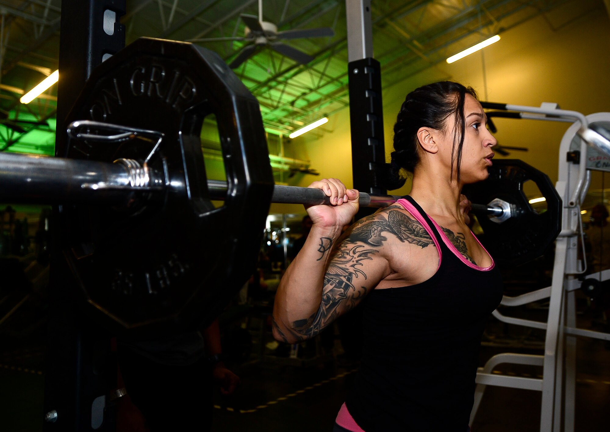 U.S. Air Force Senior Airman Kristin Delgado, 633rd Security Forces Squadron unit scheduling manager, performs squats at the Shellbank Fitness Center at Langley Air Force Base, Va., Jan. 6, 2015. Delgado aspires to compete in a female bodybuilding competition as her New Year’s resolution. Due to her schedule, she goes to the gym at 6 a.m., three times a week to reach her goals. (U.S. Air Force photo by Senior Airman Kayla Newman/Released
