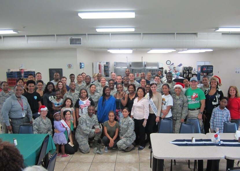 Members of Team Homestead pose for a photo at the Chapman Partnership Homeless Assistance Center's Homestead location on Dec. 25. Over 50 members donated their time serving a Christmas meal, providing activities for children, and coordinating a visit from Santa to bring holiday cheer to the families currently residing in the center. (Courtesy photo)
