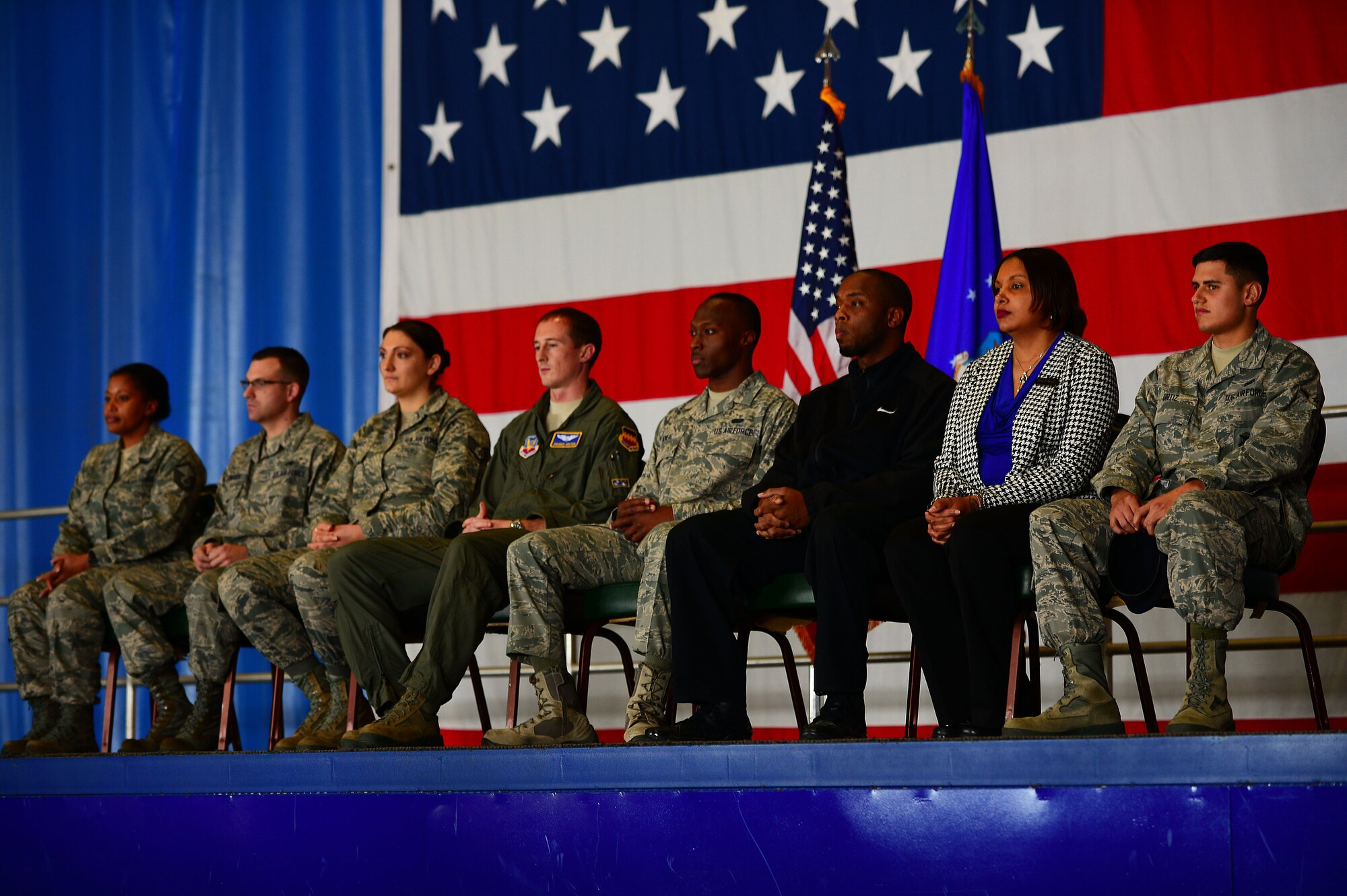 Members of Team Shaw sit on stage during an all-call at Shaw Air Force Base, S.C., Jan. 5, 2015. The all-call was held by U.S. Air Force Col. Stephen Jost, 20th Fighter Wing commander, where he announced his new initiative “Airman Up,”; a program which challenges Airmen to be the best they can be. (U.S. Air Force photo by Airman 1st Class Michael Cossaboom/Released)