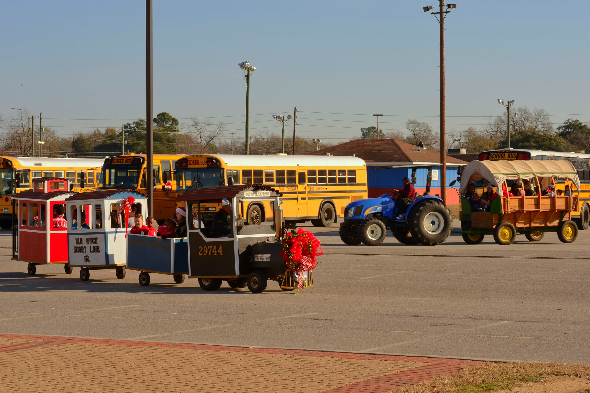 A children’s train and wagon provide a ride around the parking lot of the Sumter Civic Center, Sumter, S.C., Dec. 19, 2014. The Sumter community held a “Winter Wonderland” themed event for children with special needs, with multiple activities to participate in. (U.S. Air Force photo by Senior Airman Tabatha Zarrella/Released)