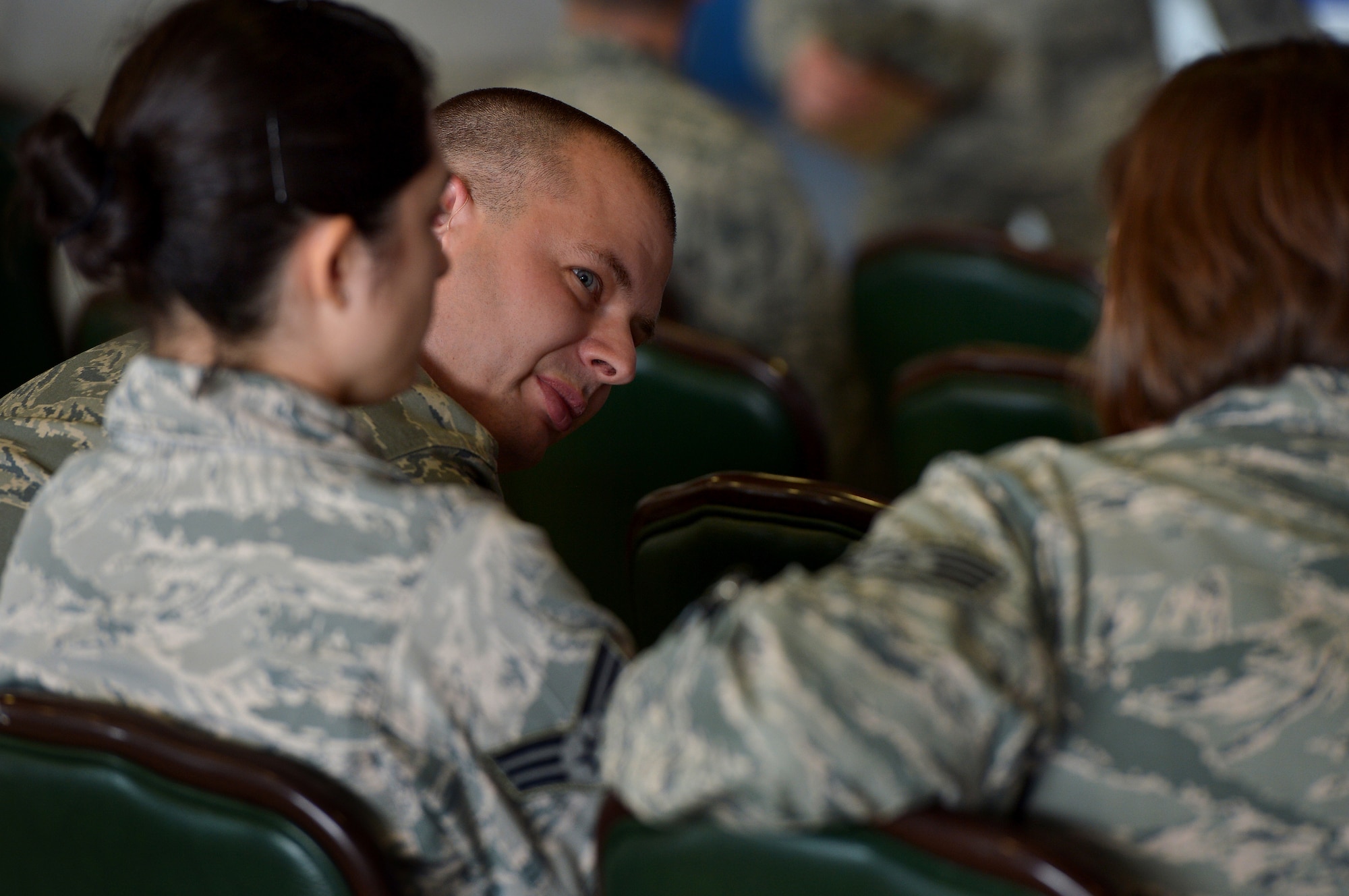 U.S. Air Force Airmen assigned to the 20th Fighter Wing talk with each other before an all-call at Shaw Air Force Base, S.C., Jan. 5, 2015. During the all-call Col. Stephen Jost, 20th FW commander, encouraged supervisors to take time to talk to their Airmen and truly get to know them in order to operate as an efficient and cohesive unit. (U.S. Air Force photo by Staff Sgt. Kenny Holston/Released)