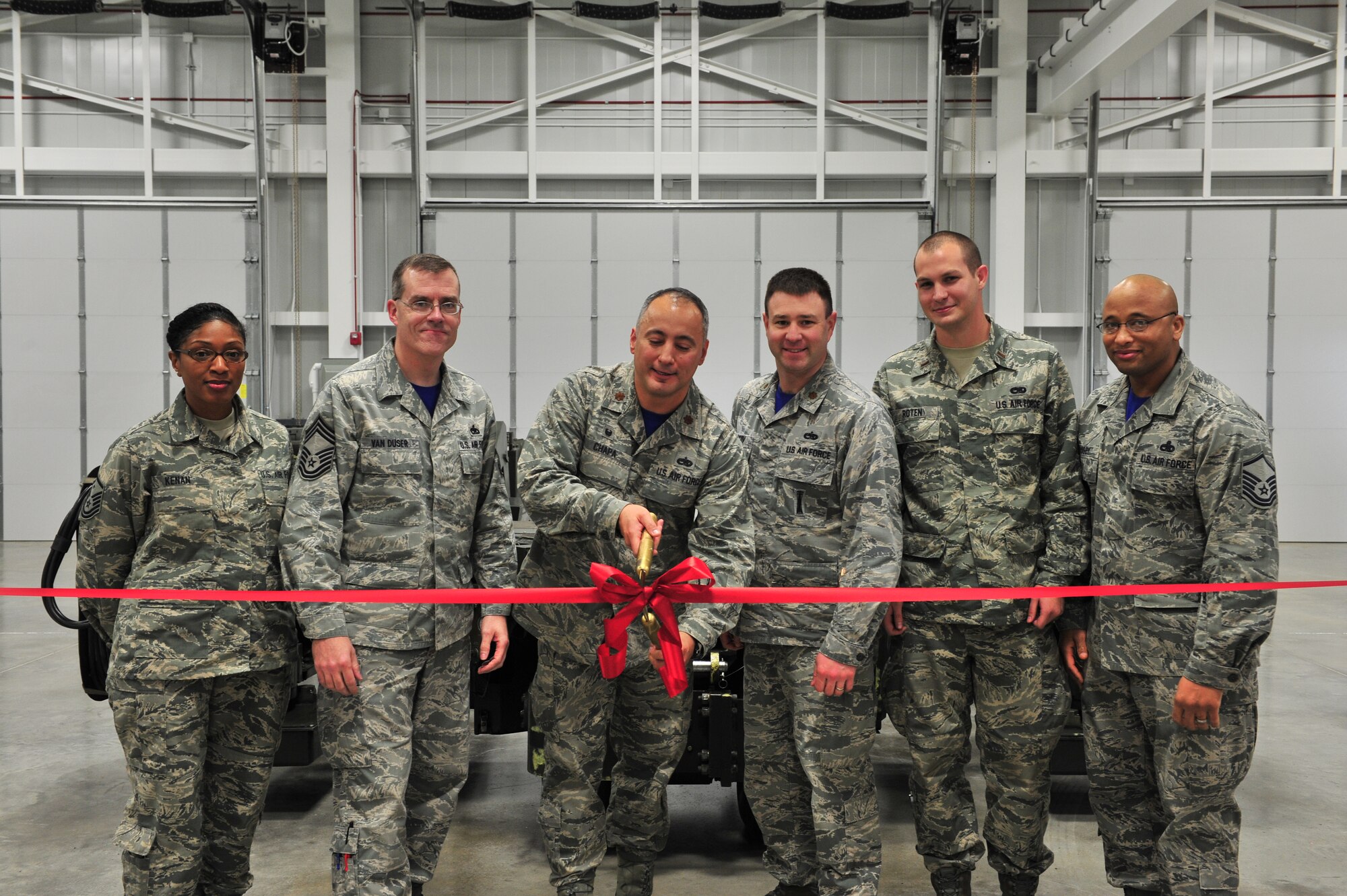 Minot leadership cut a ribbon at a Ribbon Cutting Ceremony on Minot Air Force Base, N.D., Dec. 12, 2014. Construction began on the new Aerospace Ground Equipment flight’s munition handling trailer maintenance facility in November 2013 to increase the bay’s capacity. (U.S. Air Force photo/Senior Airman Malia Jenkins)