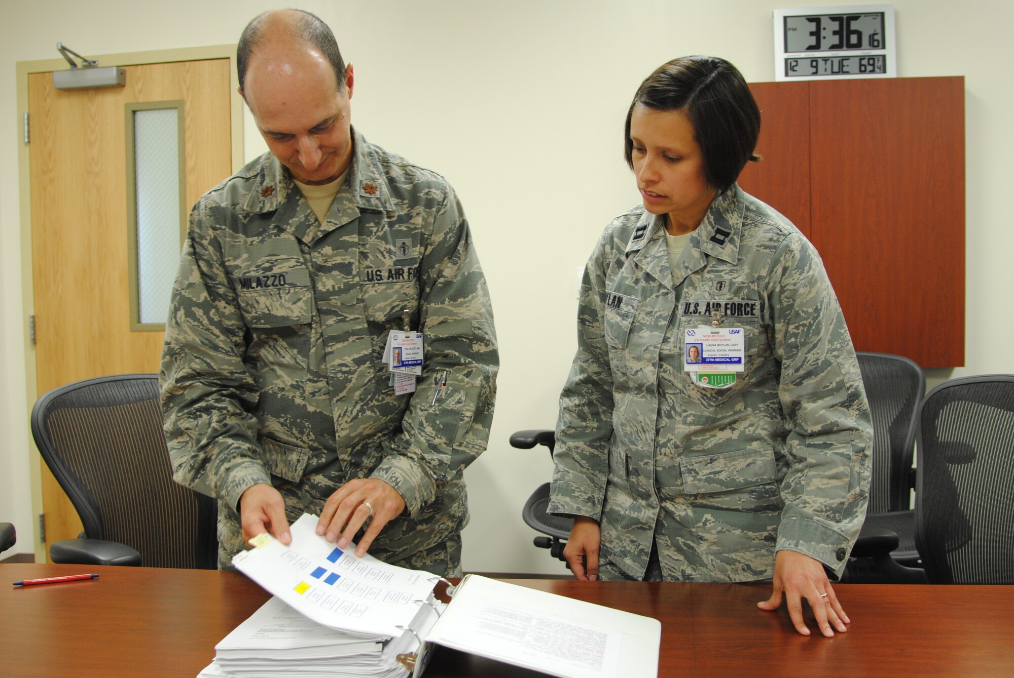 Maj. Paul Milazzo (left) and Capt. Laura Boylan, 377th Medical Group, review measures for the implementation of Kirtland's Disaster Mental Health team, which is made up of experts available as a resource to Team Kirtland members in the wake of a crisis or life-threatening event. (Photo by Jim Fisher)
