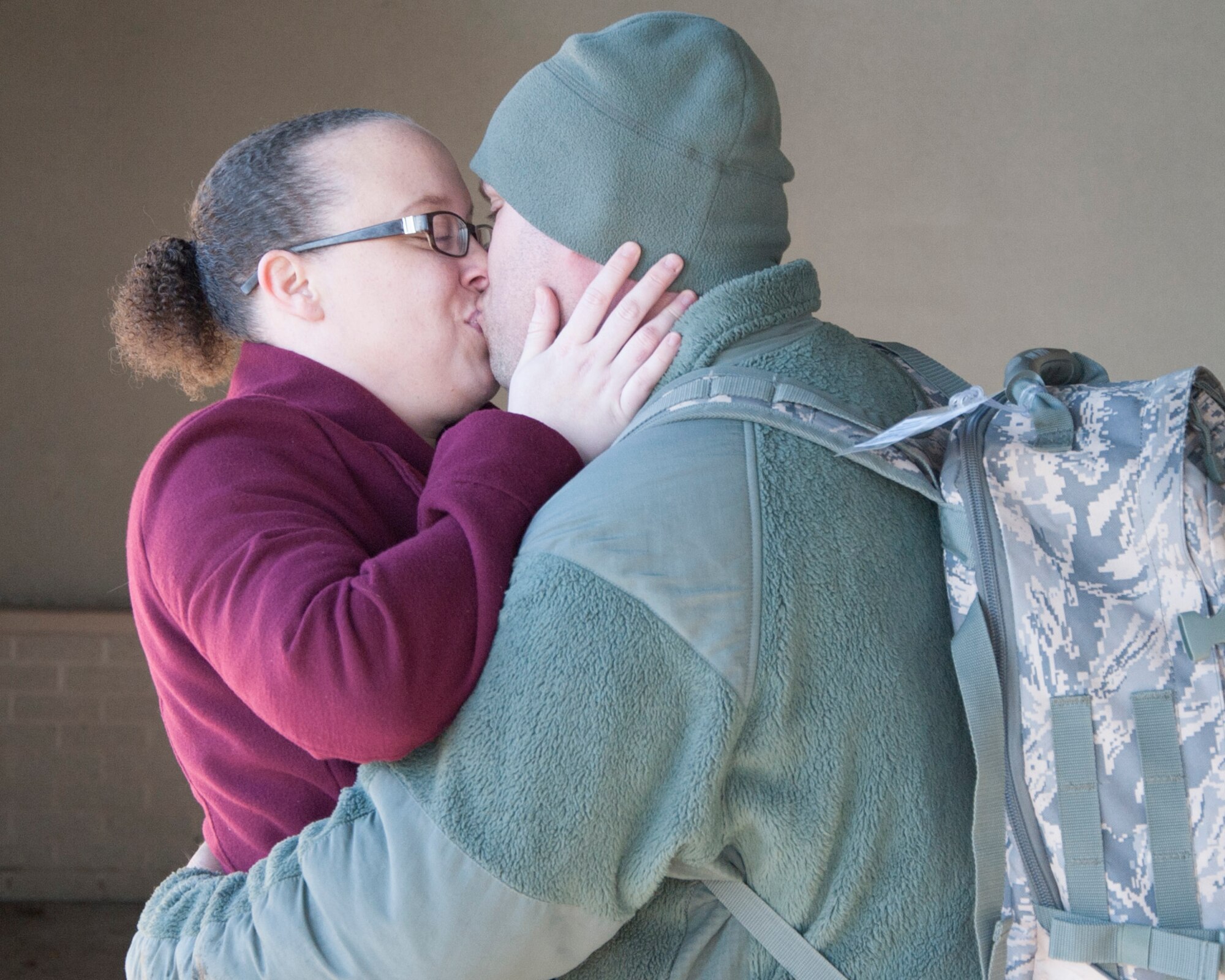Staff Sgt. Dallas Hayes, 436th Maintenance Squadron aerospace ground equipment mechanic, and his fiancée Alyson Miclette kiss  Dec. 31, 2014, at the passenger exchange terminal on Dover Air Force Base, Del. Hayes was deployed to Romania to support the retrograde mission in Afghanistan. (U.S. Air Force photo/Senior Airman Jared Duhon)