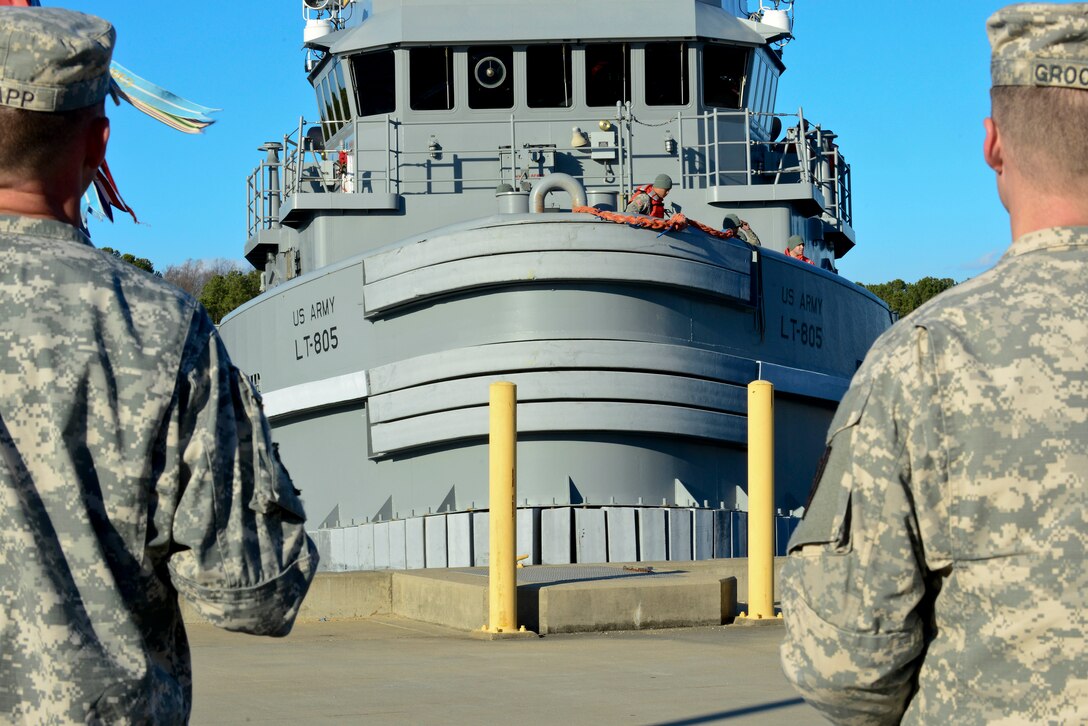 U.S. Army Soldiers from the, 7th Transportation Brigade (Expeditionary), greet a large ocean-going tug boat returns to Third Port at Fort Eustis, Va., Jan. 5, 2015, after being displaced for two years. The boat was displaced to the U.S. Coast Guard Training Center, Yorktown Pier until Third Port accommodations were made. (U.S. Air Force photo by Senior Airman Kimberly Nagle/Released) 