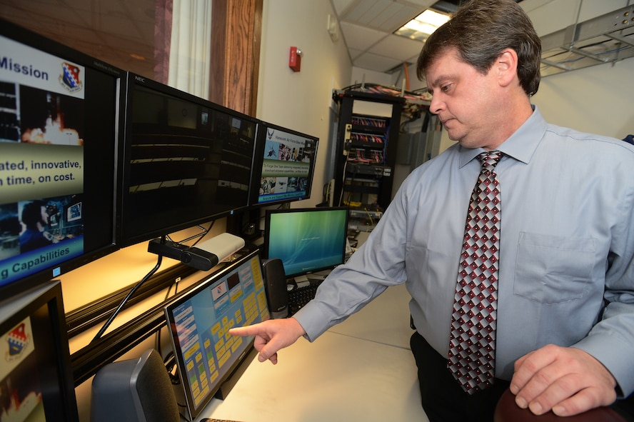 Donn DeSilva, information technology help desk specialist, Hanscom Conference Center, Hanscom Air Force tests the various features of the recently installed audio visual system in the Lexington Amphitheater control center during a training session at the Hanscom Conference Center Dec. 30. Among the $500,000 worth of improvements to the conference center’s two largest and most frequently used meeting rooms are new projectors, dual screens, podiums, smart technology, sound systems, a wireless microphone system, new audio, confidence monitors and video record capability. (U.S. Air Force photo by Jerry Saslav)