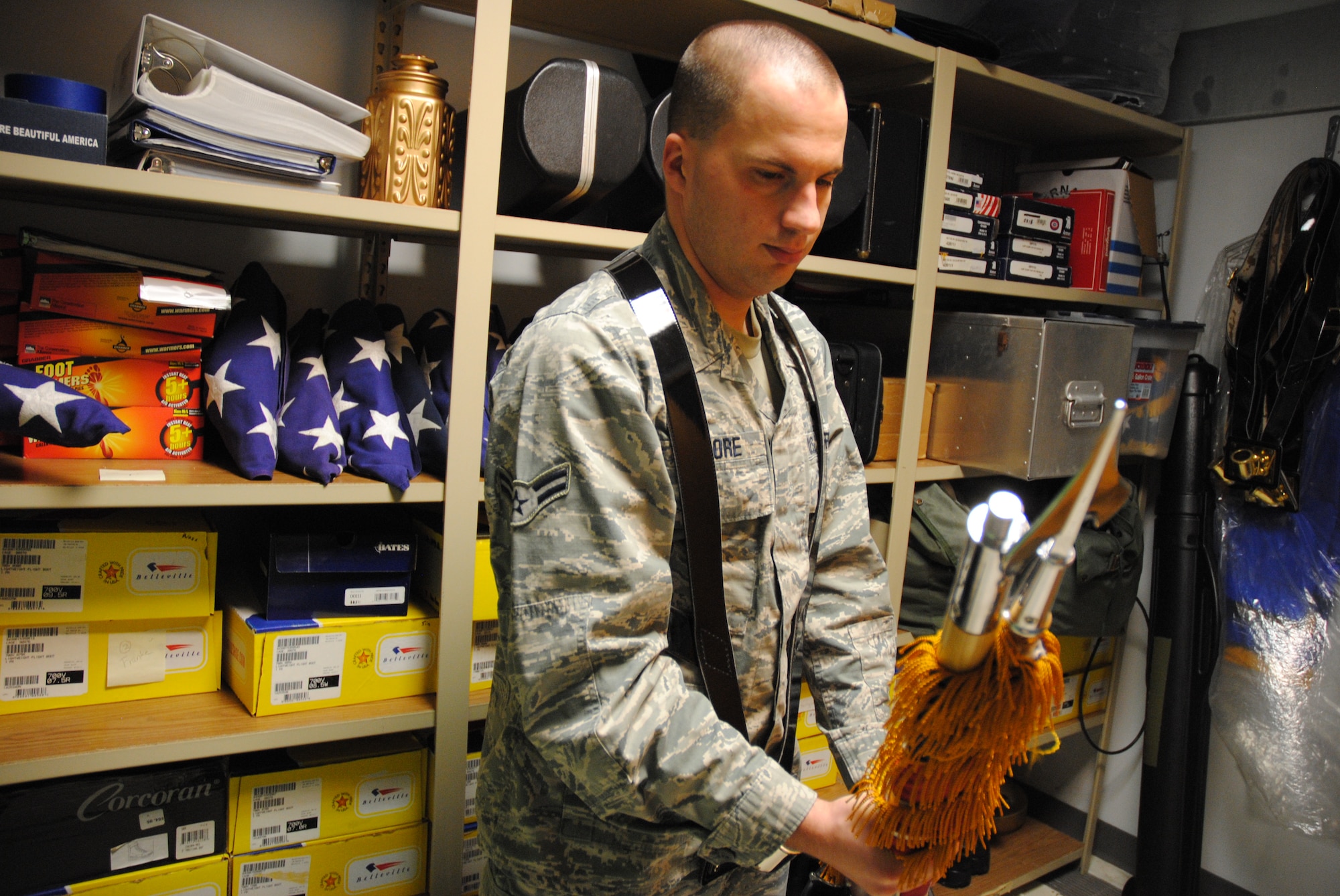 Airman 1st Class Daniel Elmore, a ceremonial guardsman with Grand Forks Air Force Base Honor Guard, ensures a U.S. flag is properly placed back into its plastic case at the Honor Guard Building on Grand Forks AFB, N.D., Dec. 24, 2014. Honor Guard members ensure both the Air Force and U.S. flags are each stored in a water proof case after every flag detail or ceremony. (U.S. Air Force photo/Staff Sgt. Luis Loza Gutierrez) 