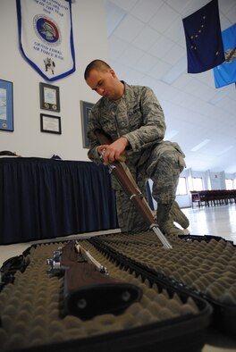 Airman 1st Class Daniel Elmore, a ceremonial guardsman with Grand Forks Air Force Base Honor Guard, cleans a practice rifle prior to placing it into a gun case Dec. 24, 2014, at the Honor Guard Building on Grand Forks AFB, N.D. The 25-year-old native from Lewisville, N.C., was named the Grand Forks AFB Warrior of the Week for the first week of January 2015. (U.S. Air Force photo/Staff Sgt. Luis Loza Gutierrez) 