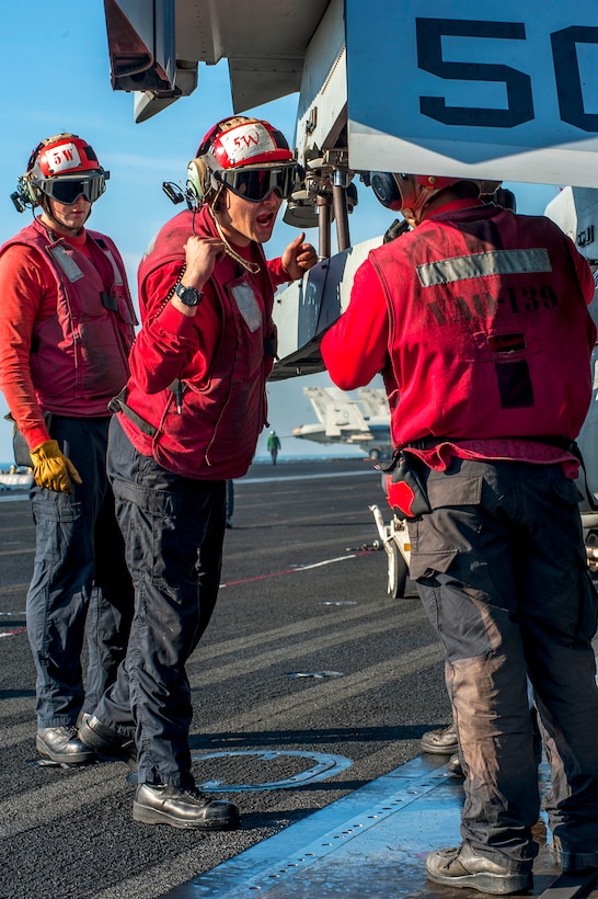 U.S. Navy Petty Officer 2nd Class Cody Askew, Center, Shouts ...