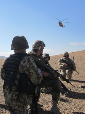 Afghans and 439th Air Expeditionary Advisor Squadron Security Forces Advisors secure a landing zone while awaiting for an Mi-17 to land during recent training.  Afghans recently complete fly away security team training that allows them to fly to locations throughout Afghanistan, and secure a landing zone, increasing the reach of the Afghan Air Force. 