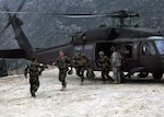 U.S. Army General Stanley A. McChrystal, commander of International Security Assistance Forces, exits a UH-60 Blackhawk from Company A, 3rd Battalion, 238th Aviation Regiment of the Delaware National Guard to greet an Afghan National Army commander during his visit to the Korengal outpost as part of Operation Mountain Decent II, April 8, 2010. During Operation Mountain Descent II, more than 500 Soldiers and nearly half a million pounds of equipment were airlifted out of the Korengal valley; this was the largest-scale movement of U.S. forces out of the valley. The Delaware unit is part of Task Force Knighthawk, a subordinate battalion of the 3rd Combat Aviation Brigade's Task Force Falcon.