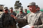 Members of A Company, 86th Engineers from 1st Battalion, 172nd Calvary of the Vermont National Guard conduct a convoy briefing before moving to the town of Charkar, Parwan province, Afghanistan, April 13, 2010.