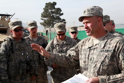 Members of A Company, 86th Engineers from 1st Battalion, 172nd Calvary of the Vermont National Guard conduct a convoy briefing before moving to the town of Charkar, Parwan province, Afghanistan, April 13, 2010.