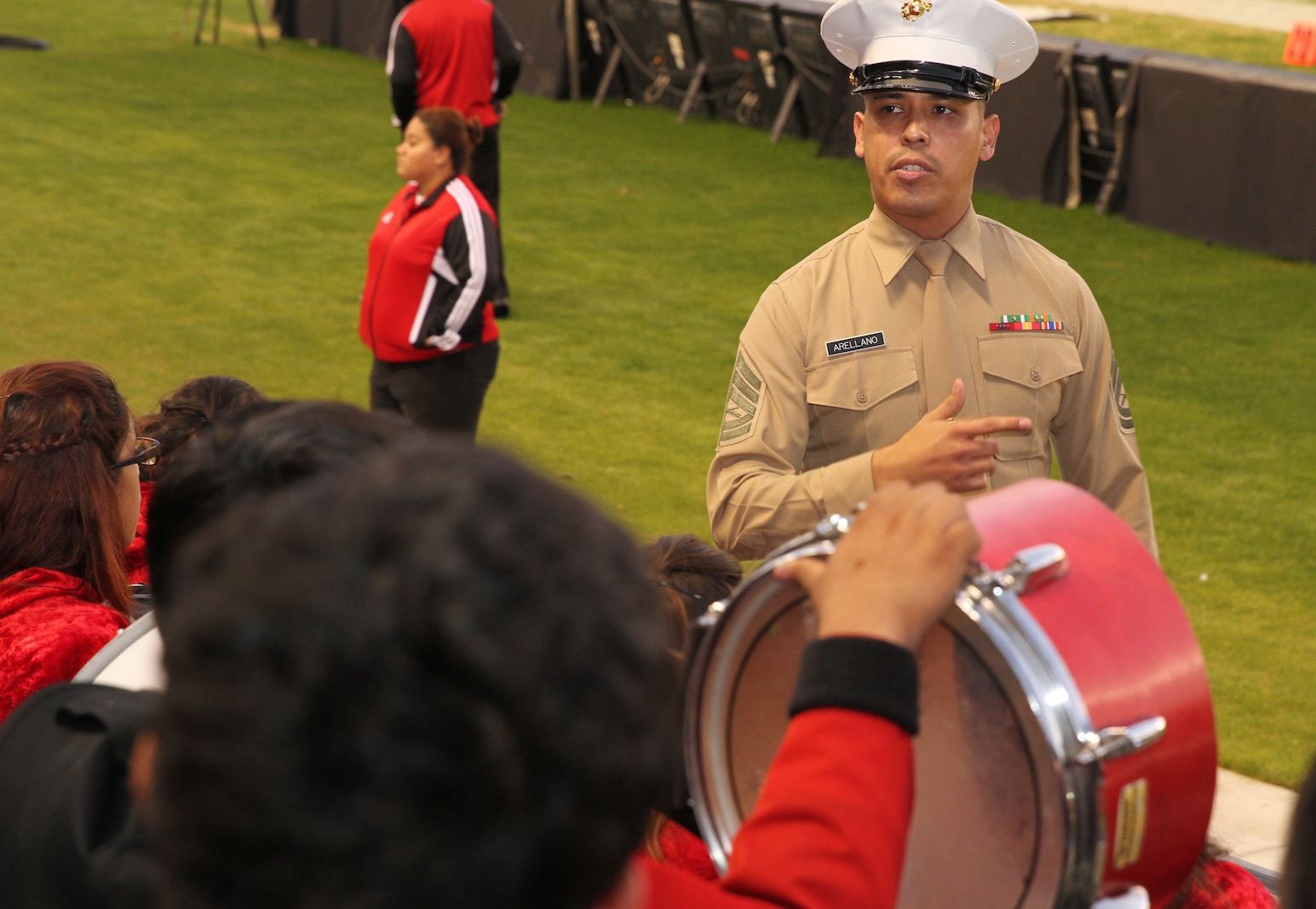 Gunnery Sergeant Christian Arellano, Musical Technical Assistant, 12th Marine Corps District, enlightens high school musicians on musical opportunities in the Marine Corps during the 2015 Semper Fidelis All-American Bowl, here today. Bands from Colony High School in Ontario, Calif., and Arroyo in El Monte, Calif., competed in a battle of the bands during halftime.