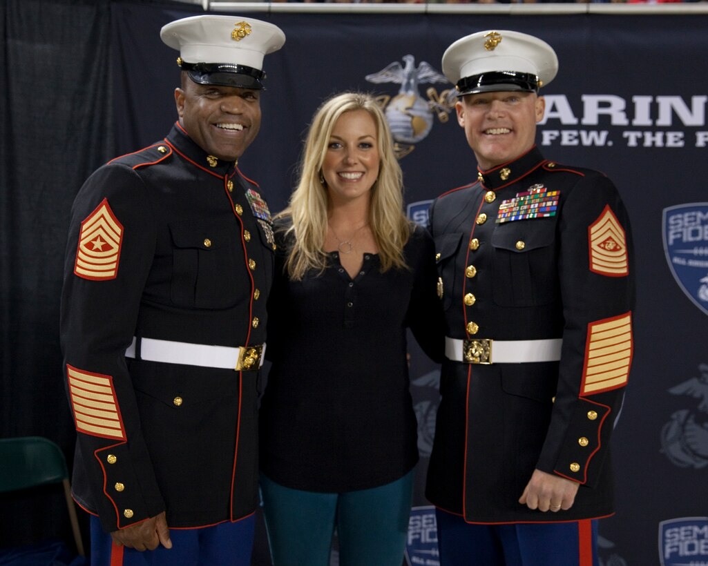 Sgt. Maj. Micheal P. Barrett, the 17th Sergeant Major of the Marine Corps, and Sgt. Maj. Michael A. Logan, the Sergeant Major of Marine Corps Recruiting Command, stands with Fox Sports reporter Krysten Peek, at the 2015 Semper Fidelis All-American Bowl, at the StubHub Center, Carson, Calif., on Jan. 4, 2015. (U.S. Marine Corps photo by Lance Cpl. Samantha K. Draughon/ Released)