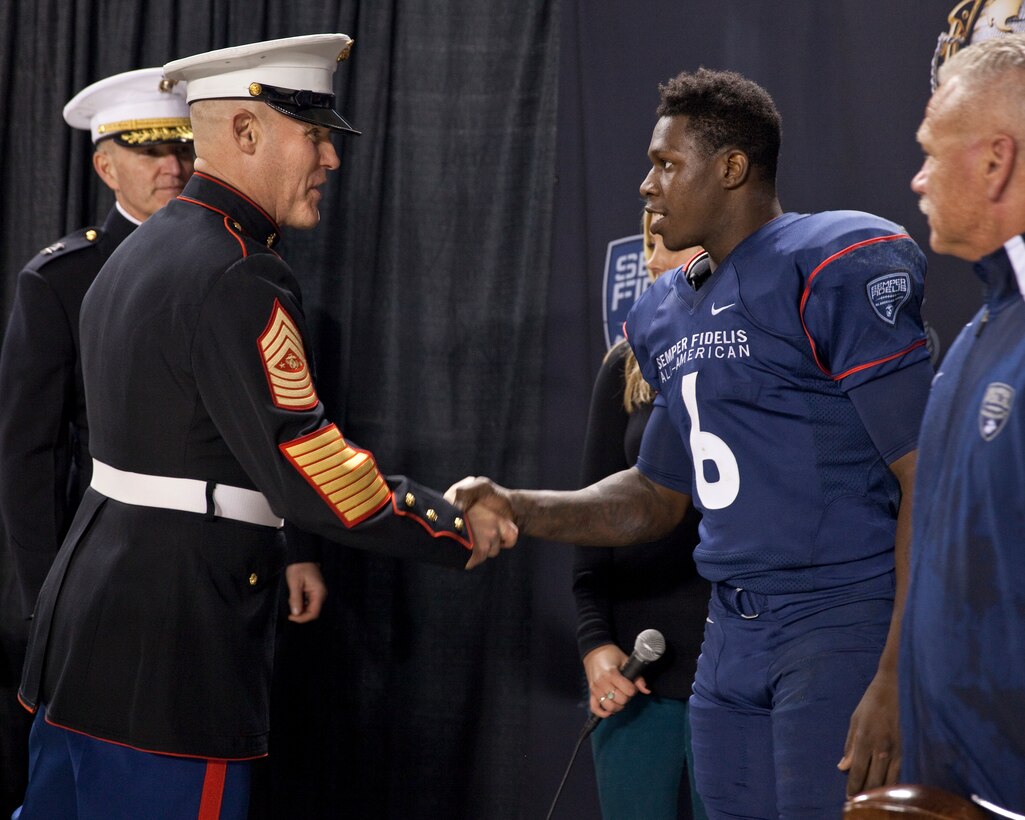 Sgt. Maj. Micheal P. Barrett, the 17th Sergeant Major of the Marine Corps, congratulates the 2015 Semper Fidelis All American Bowl MVP, Joe Burrow, after the 2015 Semper Fidelis All-American Bowl, at the StubHub Center, Carson, Calif., on Jan. 4, 2015. (U.S. Marine Corps photo by Lance Cpl. Samantha K. Draughon/ Released)