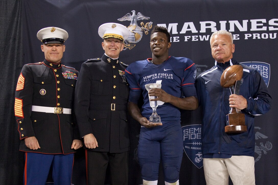 Sgt. Maj. Micheal P. Barrett, the 17th Sergeant Major of the Marine Corps, congratulates the 2015 Semper Fidelis All American Bowl MVP, Joe Burrow, after the 2015 Semper Fidelis All-American Bowl, at the StubHub Center, Carson, Calif., on Jan. 4, 2015. (U.S. Marine Corps photo by Lance Cpl. Samantha K. Draughon/ Released)