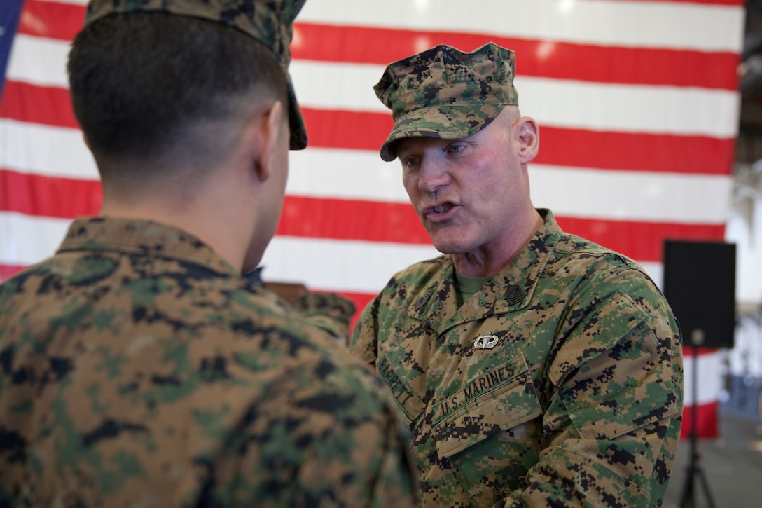 Sgt. Maj. Micheal P. Barrett, the 17th Sergeant Major of the Marine Corps, congratulates newly promoted Sgt. Marcos Gutierrez at his promotion ceremony aboard the USS America (LHA-6), at Naval Base San Diego, Calif., on Jan. 5, 2015. (U.S. Marine Corps photo by Lance Cpl. Samantha K. Draughon/ Released) 
