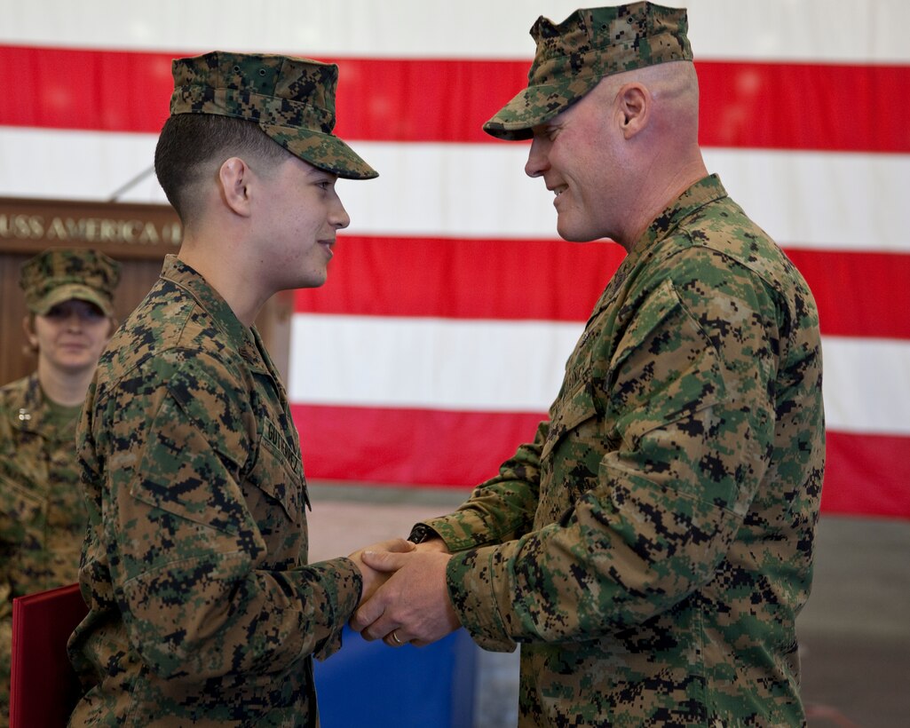 Sgt. Maj. Micheal P. Barrett, the 17th Sergeant Major of the Marine Corps, congratulates newly promoted Sgt. Marcos Gutierrez at his promotion ceremony aboard the USS America (LHA-6), at Naval Base San Diego, Calif., on Jan. 5, 2015. (U.S. Marine Corps photo by Lance Cpl. Samantha K. Draughon/ Released) 